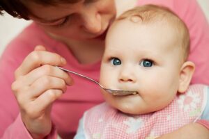 Mother-feeding-baby-food